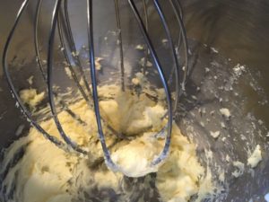 Butter being whipped in a mixer.
