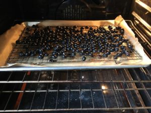 Baking blueberries for making blueberry gummy buttons.